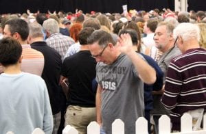 A Trump fan waves off the media in disgust.